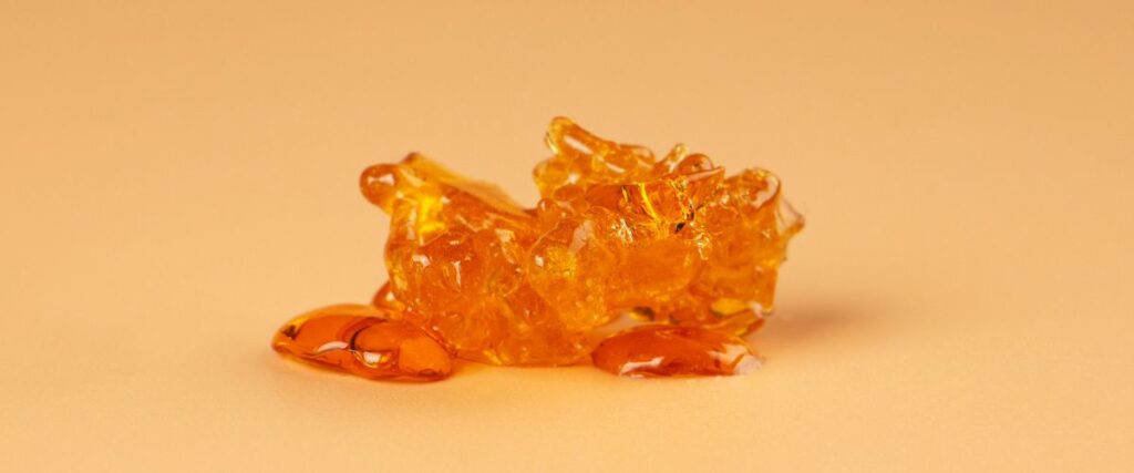 A chunk of cannabis concentrate on a plain background