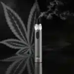 Modern vape pen emitting vapor, ideal for enjoying Puffy THCA products in a sleek and convenient way.