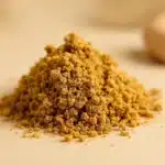 A close-up of THCA classic hash with a rich, amber-brown color and slightly textured surface, placed on a clean, neutral background. The focus is on the purity and dense concentration of the hash, capturing the subtle details and smooth edges that emphasize its quality.