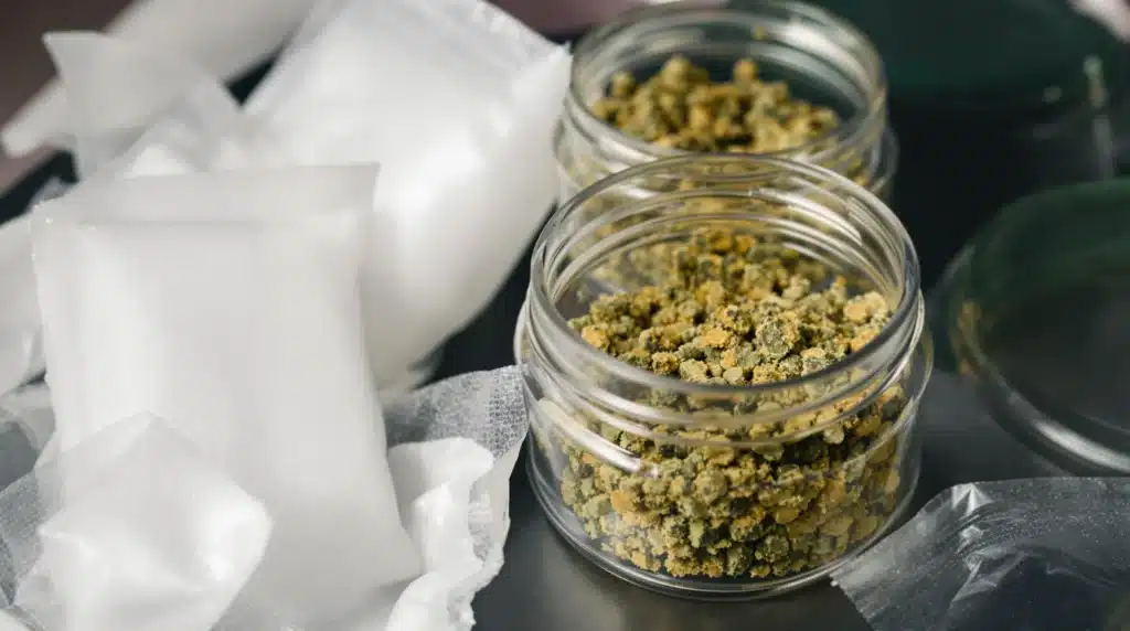 Airtight containers with cannabis pollen and silica gel packs for proper storage and longevity.