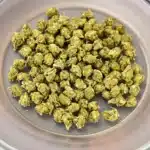 Cannabis buds prepared for drying pot in microwave on a microwave-safe plate.