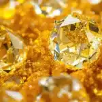 Yellow BHO Diamonds glimmering with a soft shine on a bright surface.
