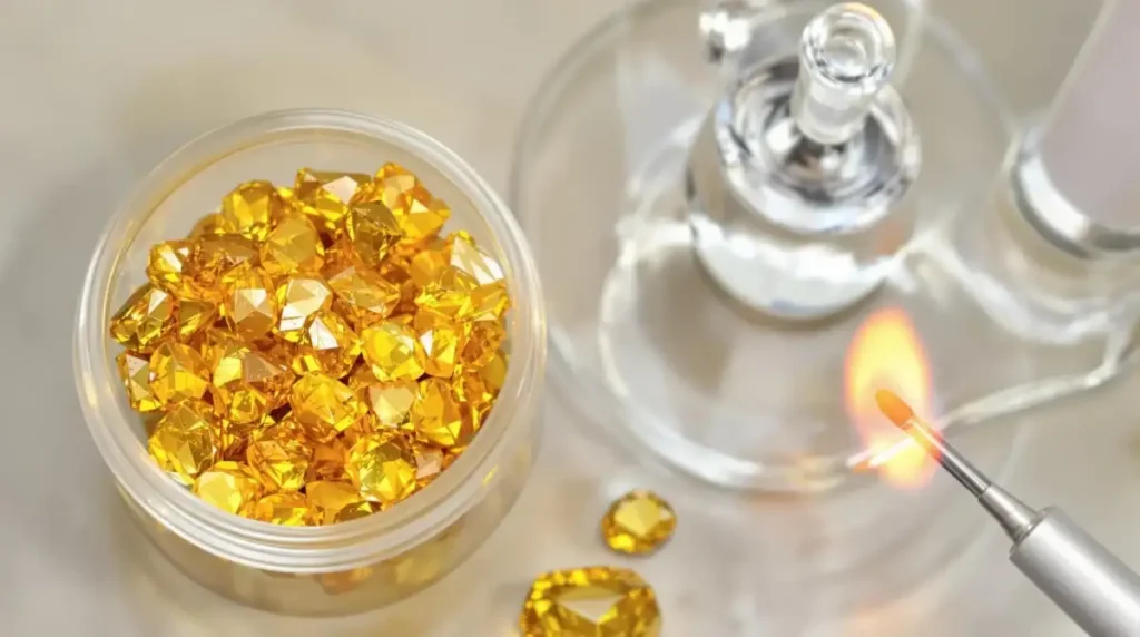 Close-up of cannabis kief being collected in a red grinder with joints and buds nearby.
