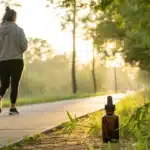 Individual enjoying nature with a cannabis product, representing cannabis for asthma treatment support.