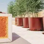 Hyper-realistic image showing cross-sections of large black pots revealing layered soil and white pebbles with tall cannabis plants.