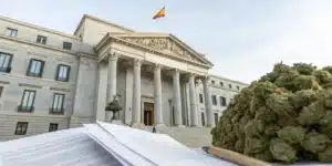 Realistic image of a Spanish government building with legal documents, symbolizing Spain cannabis laws and regulatory oversight.