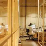 Wide-angle view of a cannabis research lab with scientists working at computers